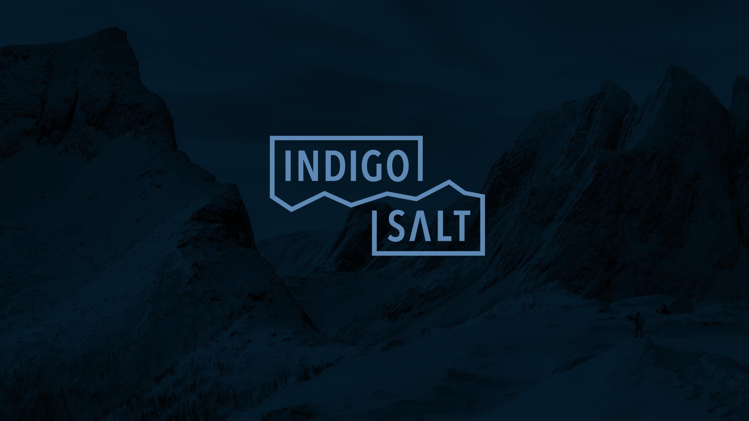 Indigo Salt logo on mountain background image.